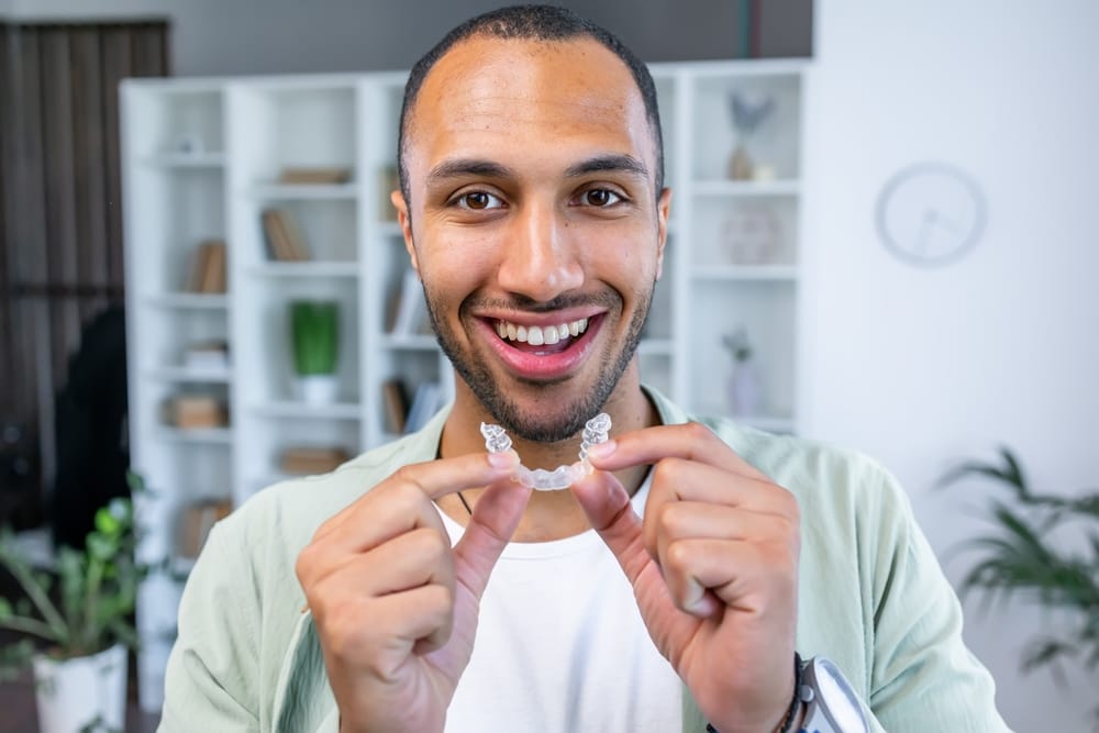 Man holding an Invisalign Oro Valley AZ
