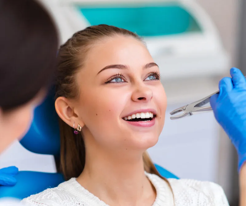 Tooth extraction beautiful girl in dentistry