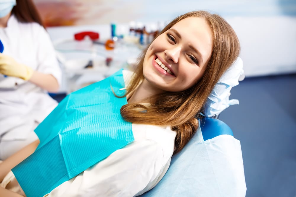 Woman sitting on a dental chair - Root Canal Tucson