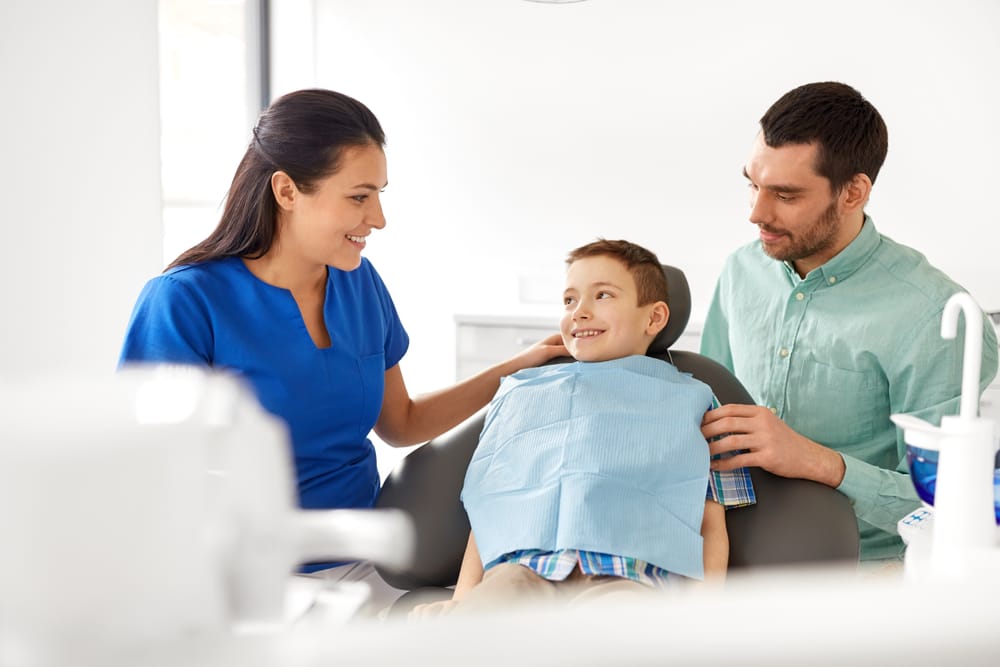 Young boy with father on a dental checkup - Oro Valley Pediatric Dentist