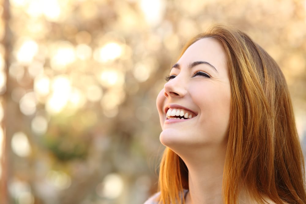 Woman outdoors smiling - Teeth Whitening Oro Valley AZ